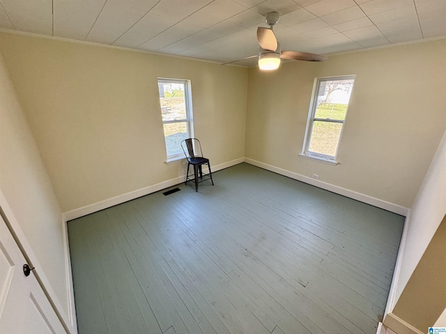 unfurnished room with hardwood / wood-style flooring, ornamental molding, and ceiling fan