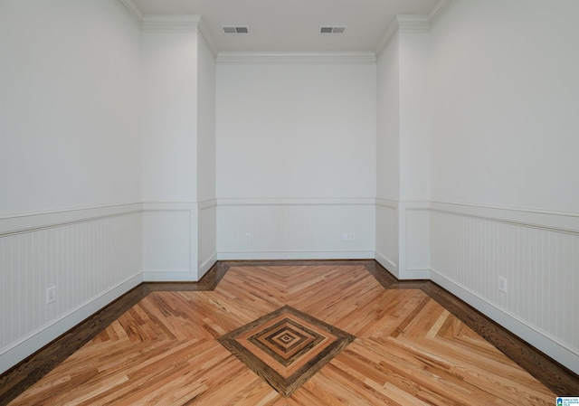 unfurnished room featuring parquet flooring and crown molding