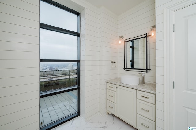 bathroom with ornamental molding and vanity