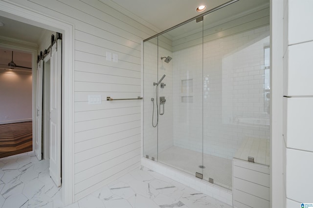 bathroom featuring ornamental molding and walk in shower