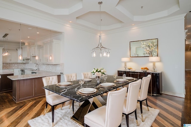 dining area with ornamental molding, dark wood-type flooring, sink, and coffered ceiling