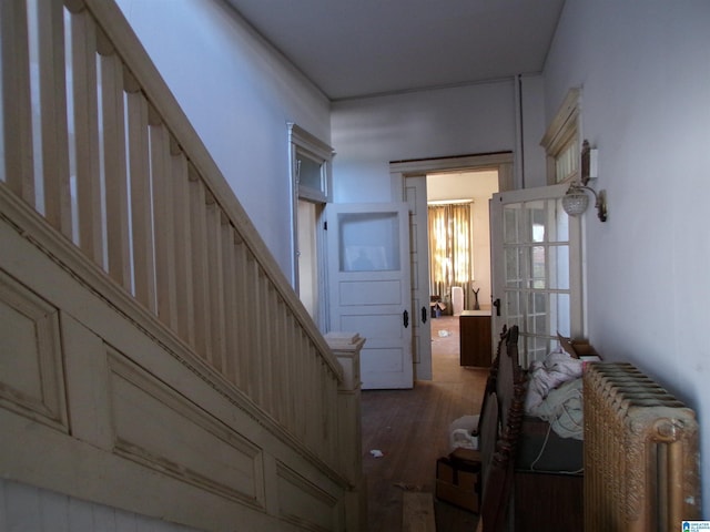 interior space featuring radiator heating unit and dark hardwood / wood-style flooring