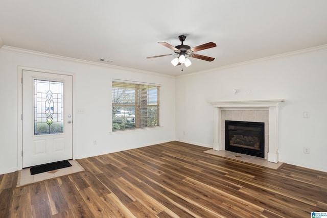 unfurnished living room featuring dark hardwood / wood-style flooring, a fireplace, and ornamental molding