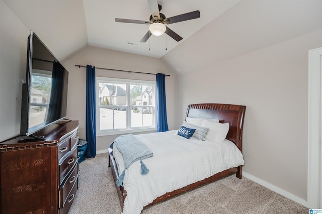 carpeted bedroom featuring ceiling fan, vaulted ceiling, and multiple windows