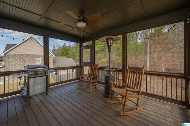 wooden terrace featuring area for grilling and ceiling fan