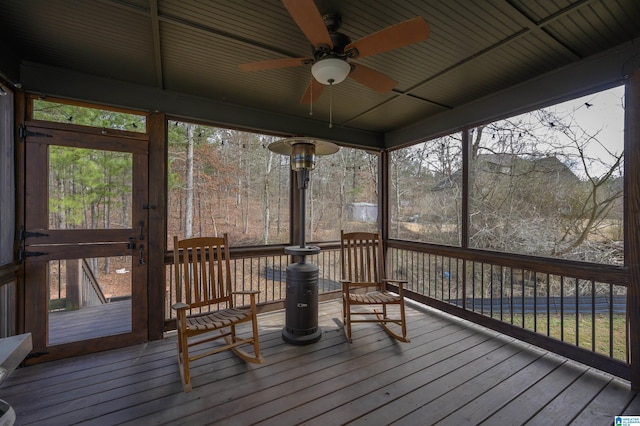 sunroom / solarium featuring ceiling fan