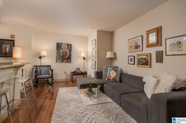 living room featuring dark wood-type flooring and baseboards