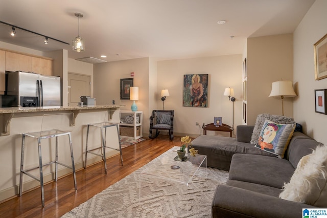 living area featuring dark wood-style floors and rail lighting