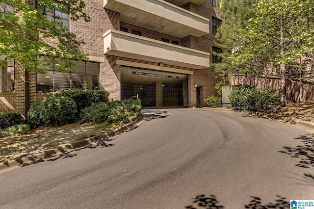 view of building exterior with driveway and an attached garage