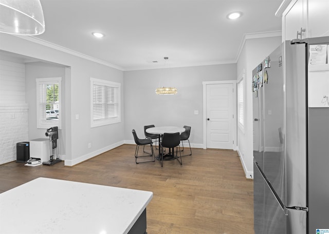 dining space featuring crown molding and dark hardwood / wood-style flooring