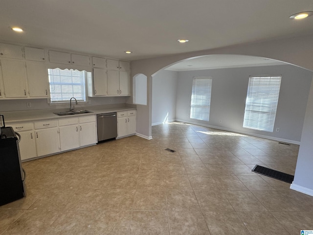 kitchen with white cabinetry, sink, stainless steel dishwasher, and light tile patterned floors