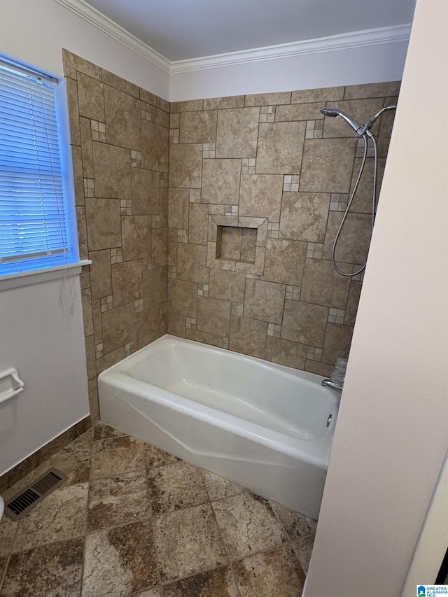 bathroom featuring tiled shower / bath combo and ornamental molding