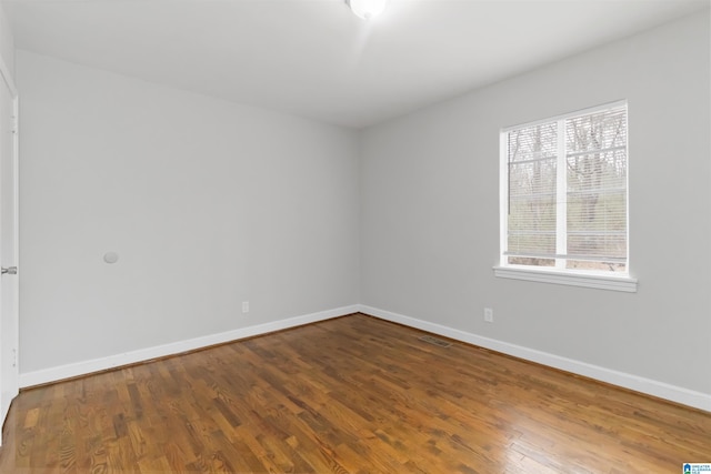 spare room with hardwood / wood-style flooring