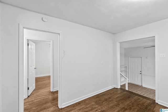 empty room with baseboards and dark wood-style flooring