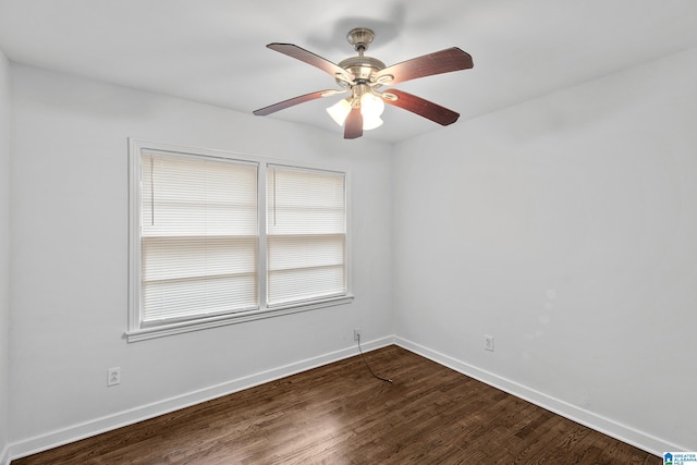 empty room with ceiling fan, baseboards, and dark wood-type flooring