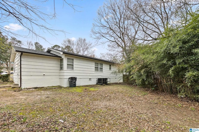 back of house with central AC unit