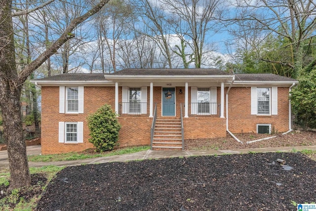 view of front of house featuring a porch and brick siding