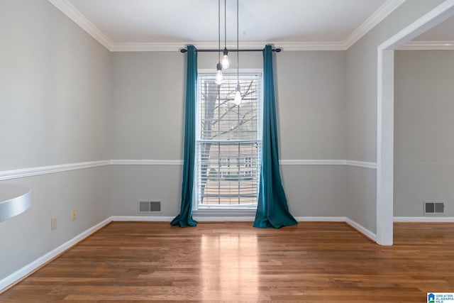 unfurnished dining area with ornamental molding, wood finished floors, and visible vents