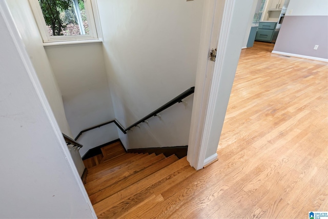 stairs featuring baseboards and wood finished floors