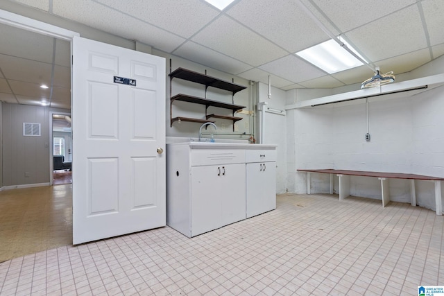 laundry area with light floors, visible vents, and a sink