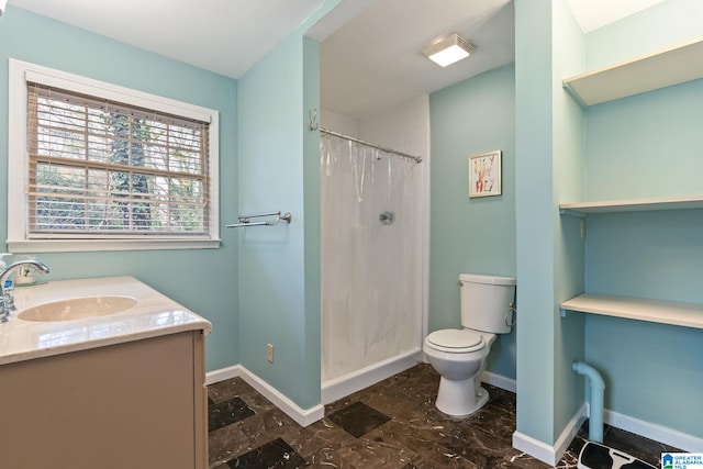 full bath featuring a shower stall, toilet, vanity, and baseboards