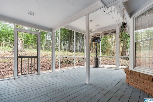 unfurnished sunroom with a ceiling fan