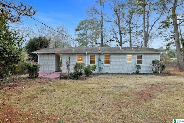 ranch-style house with a patio and a front yard