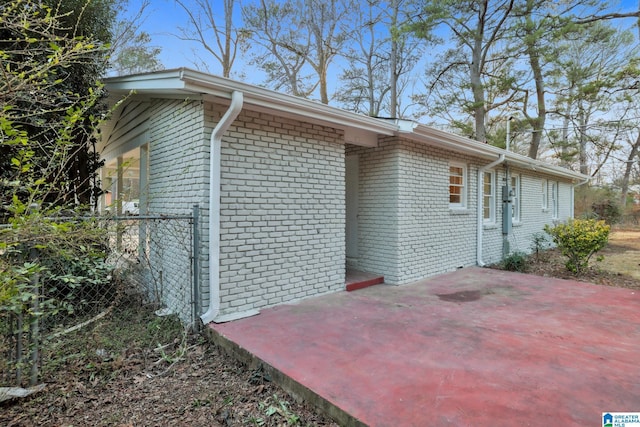 view of property exterior with a patio