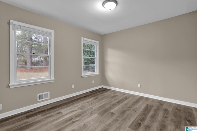 unfurnished room with wood-type flooring