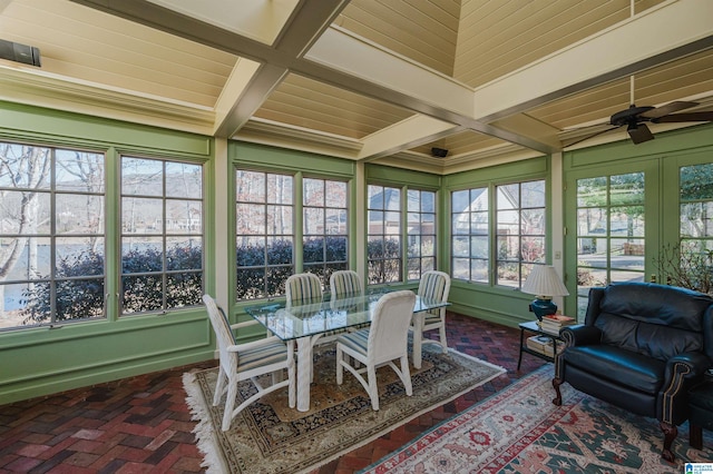 sunroom / solarium with ceiling fan and beamed ceiling