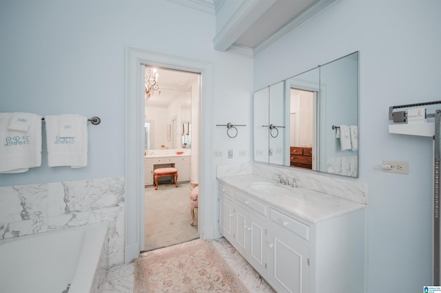 bathroom with a bathing tub, ornamental molding, and vanity