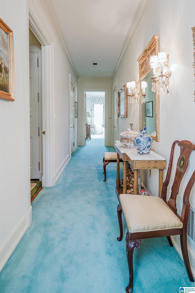 hall with ornamental molding and carpet flooring