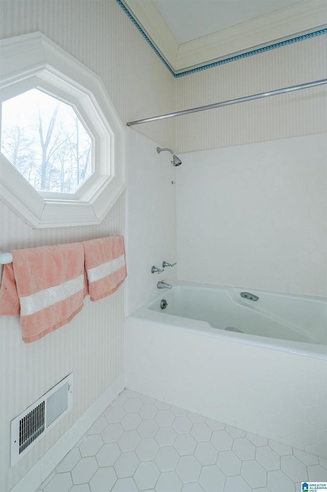 bathroom with tile patterned floors and shower / washtub combination