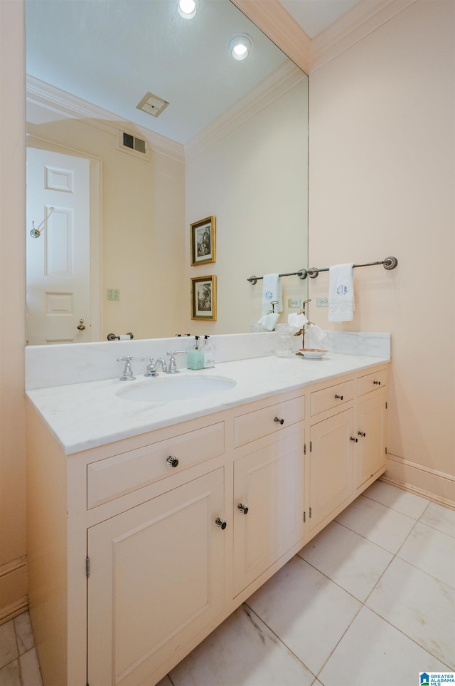 bathroom featuring tile patterned flooring, crown molding, and vanity