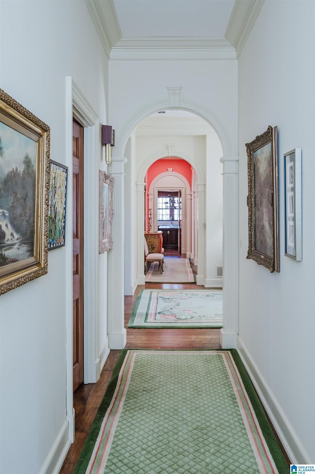 hallway with dark hardwood / wood-style flooring and ornamental molding