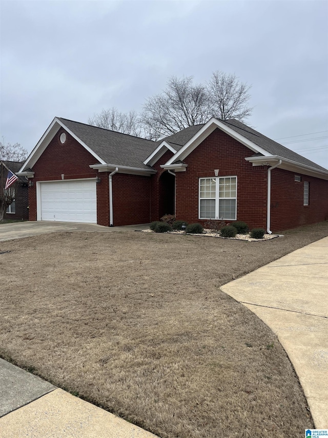 ranch-style home featuring an attached garage, driveway, and brick siding