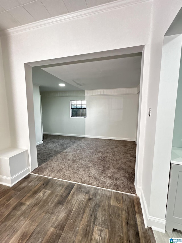 interior space featuring crown molding and dark hardwood / wood-style floors