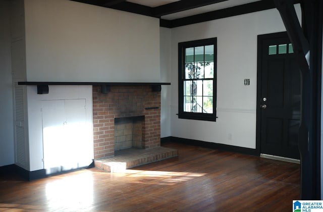 unfurnished living room featuring beamed ceiling, dark hardwood / wood-style floors, and a fireplace