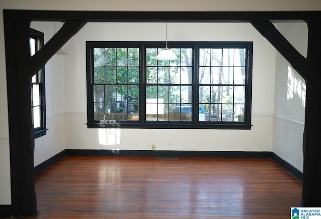 unfurnished room featuring dark wood-type flooring