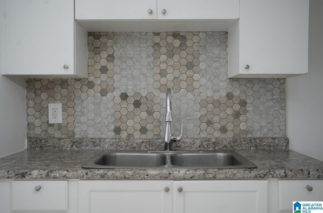 kitchen with white cabinetry, sink, and decorative backsplash