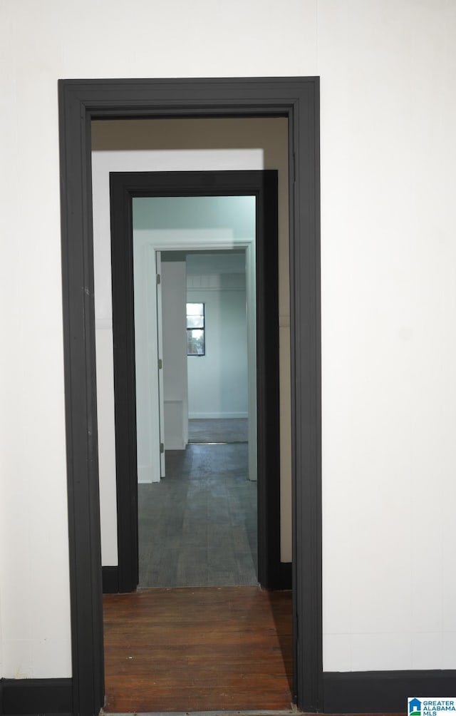 corridor with dark wood-type flooring