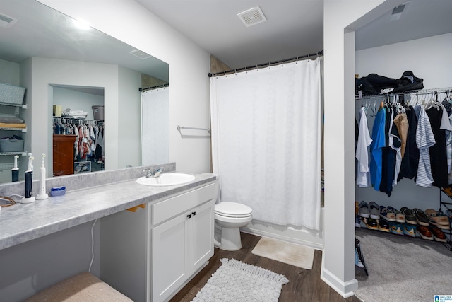 full bathroom with hardwood / wood-style flooring, vanity, toilet, and shower / bath combo with shower curtain