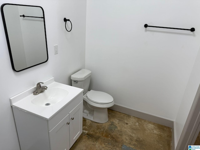 bathroom featuring vanity, concrete floors, and toilet