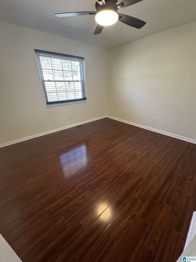 spare room featuring ceiling fan and dark hardwood / wood-style flooring