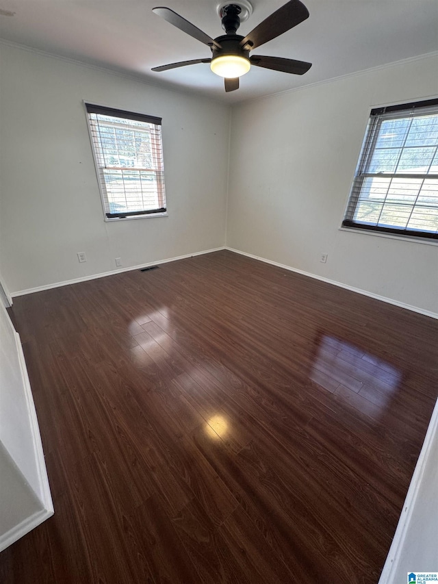 unfurnished room with ceiling fan, ornamental molding, and dark hardwood / wood-style flooring