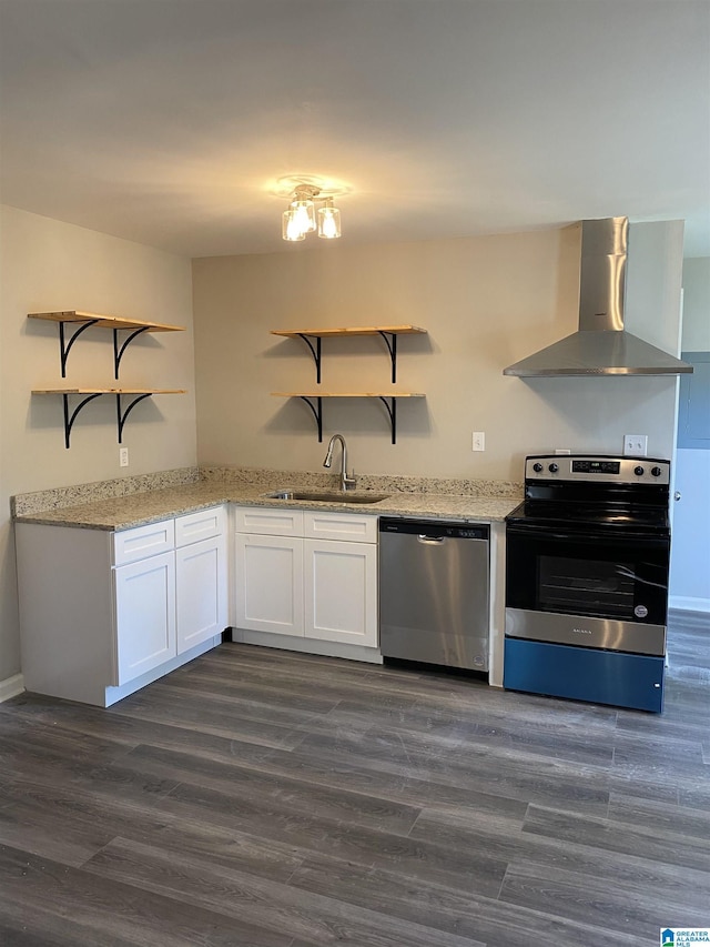 kitchen with sink, wall chimney range hood, appliances with stainless steel finishes, white cabinetry, and dark hardwood / wood-style flooring