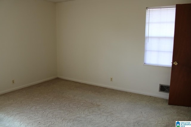 empty room with plenty of natural light and light carpet