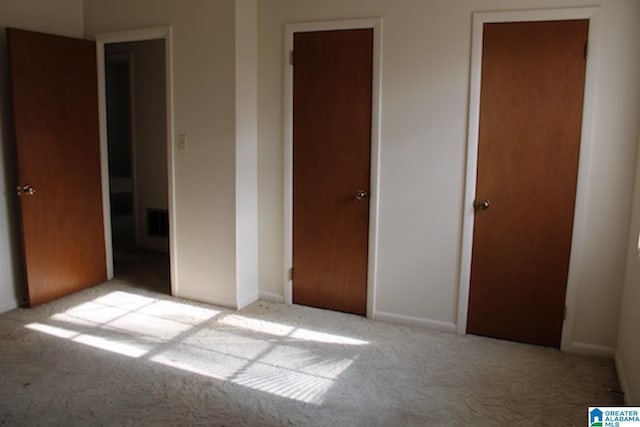 unfurnished bedroom with light carpet