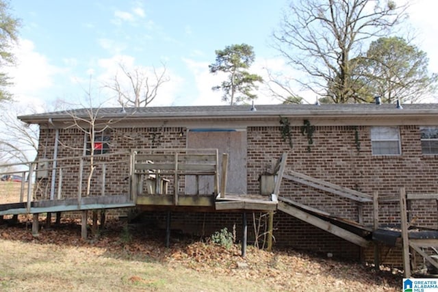 back of house featuring a wooden deck