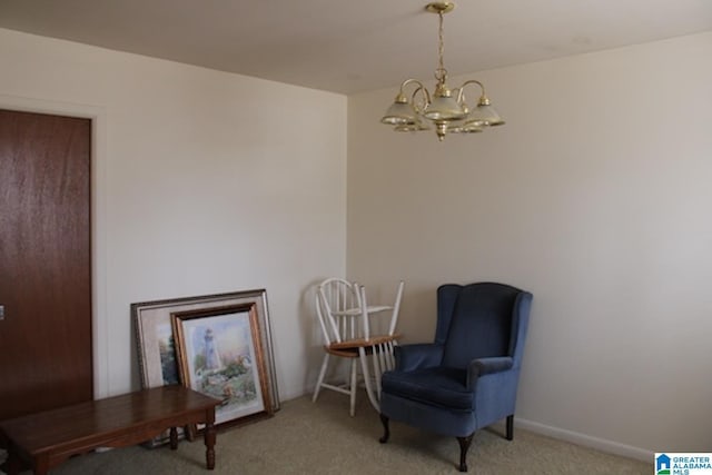 living area featuring a chandelier and carpet